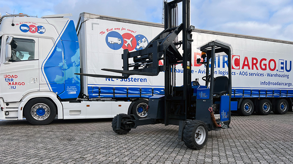 Truck mounted forklift in front of truck