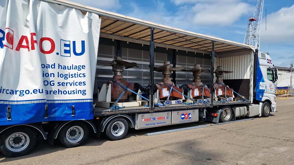 Truck delivers ship propellers in harbour Ship propellers supply with truck